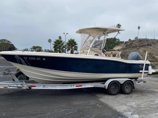 Scout 242 Sportfish 2007 Scout 242 Sportfish boat on trailer, parked outdoors.