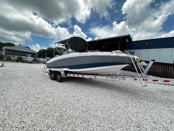 NauticStar 203 DC 2024 NauticStar 203 DC boat on trailer, parked outdoors under cloudy sky.