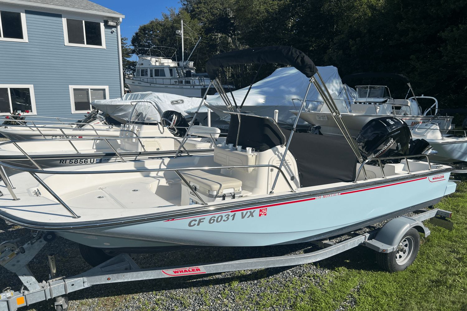 Boston Whaler 170 Montauk 2024 Boston Whaler 170 Montauk boat on trailer, parked outdoors.