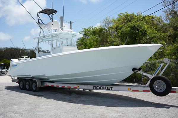 Contender 39ST 39 ST 2024 Contender 39ST boat on trailer, parked outdoors, side view.