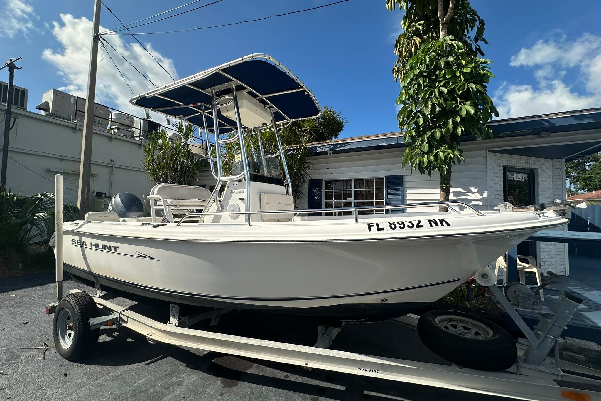 Sea Hunt Triton 186 2007 Sea Hunt Triton 186 boat on trailer, parked outdoors under blue sky.