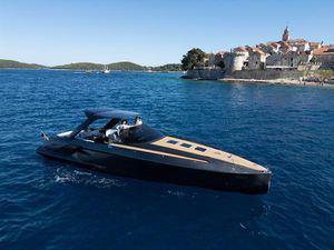 Frauscher 1414 Demon 2024 Frauscher 1414 Demon yacht cruising near historic coastal town.