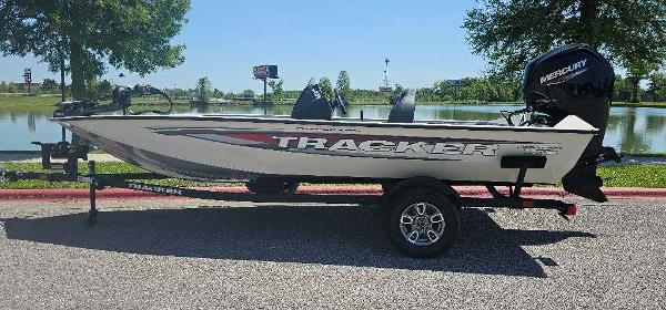 Tracker Pro Team 175 2025 Tracker Pro Team 175 boat on trailer by a lake, sunny day.