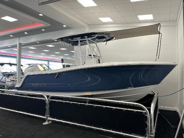 Blackfin 222CC 2025 Blackfin 222CC boat displayed in a showroom with modern lighting.
