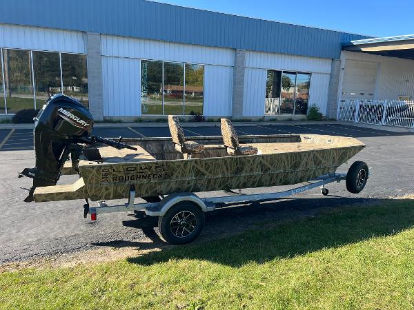 Lowe Roughneck 1760 2025 Lowe Roughneck 1760 boat on trailer, parked outside a building.
