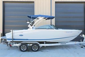 Cobalt CS23 Surf 2020 Cobalt CS23 Surf boat on trailer, parked outside industrial building.