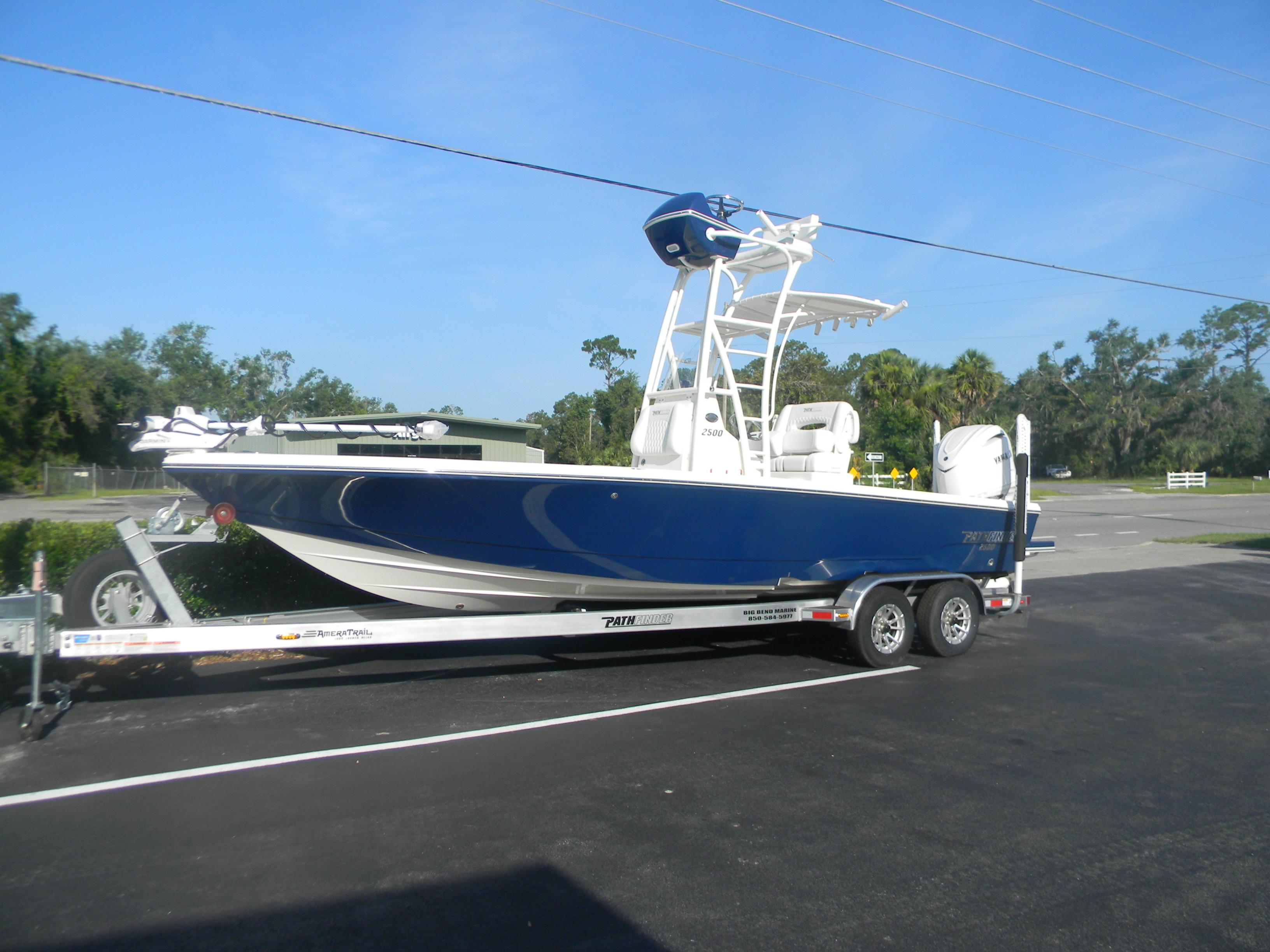 Pathfinder 2500 Hybrid 2026 Pathfinder 2500 Hybrid boat on trailer, parked outdoors under clear blue sky.
