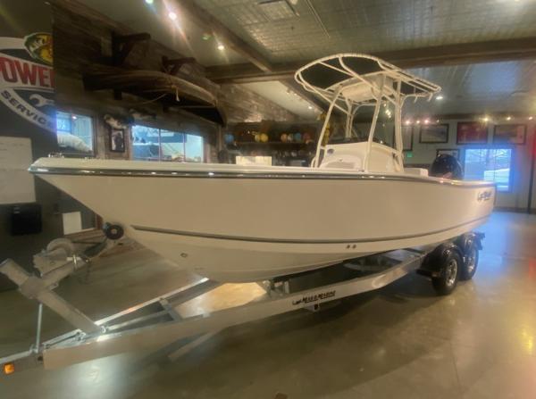 Mako 214 CC 2024 Mako 214 CC center console boat on trailer in showroom.