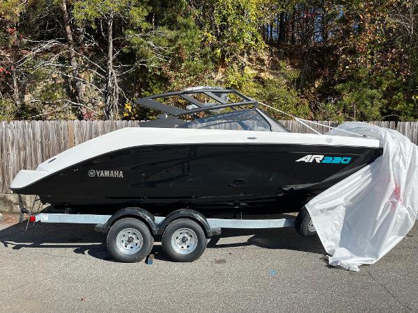 Yamaha Boats AR220 2025 Yamaha AR220 boat on trailer, partially covered, outdoors.