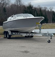 Key West 203 DFS 2025 Key West 203 DFS boat on trailer near a pond, overcast sky.