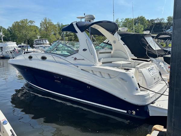 Sea Ray 320 Sundancer 2006 Sea Ray 320 Sundancer boat docked in a marina, featuring sleek design and blue hull.