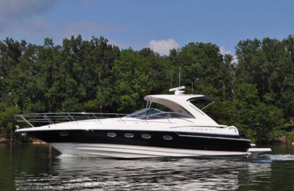 Regal 4260 COMMODORE 2005 Regal 4260 Commodore yacht cruising on a calm lake with lush green trees.