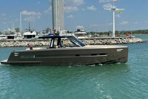 Fjord 48 Open 2017 Fjord 48 Open yacht cruising near a marina with a modern cityscape backdrop.