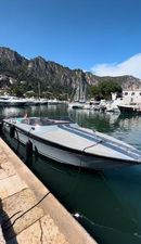 Monte Carlo 30 Offshorer 1989 Monte Carlo 30 Offshorer docked in scenic marina with mountains.