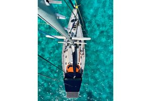 Comena Orama 48 Aerial view of Comema Orama 48 sailboat on clear turquoise water, 1987 model.