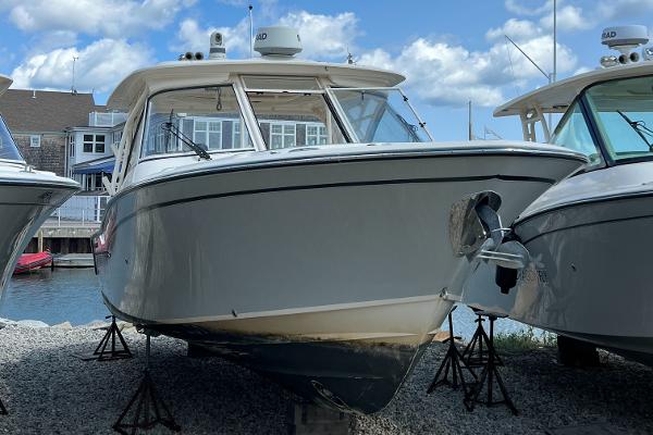 Grady-White Freedom 325 2018 Grady-White Freedom 325 boat on stands, dockside, under a partly cloudy sky.