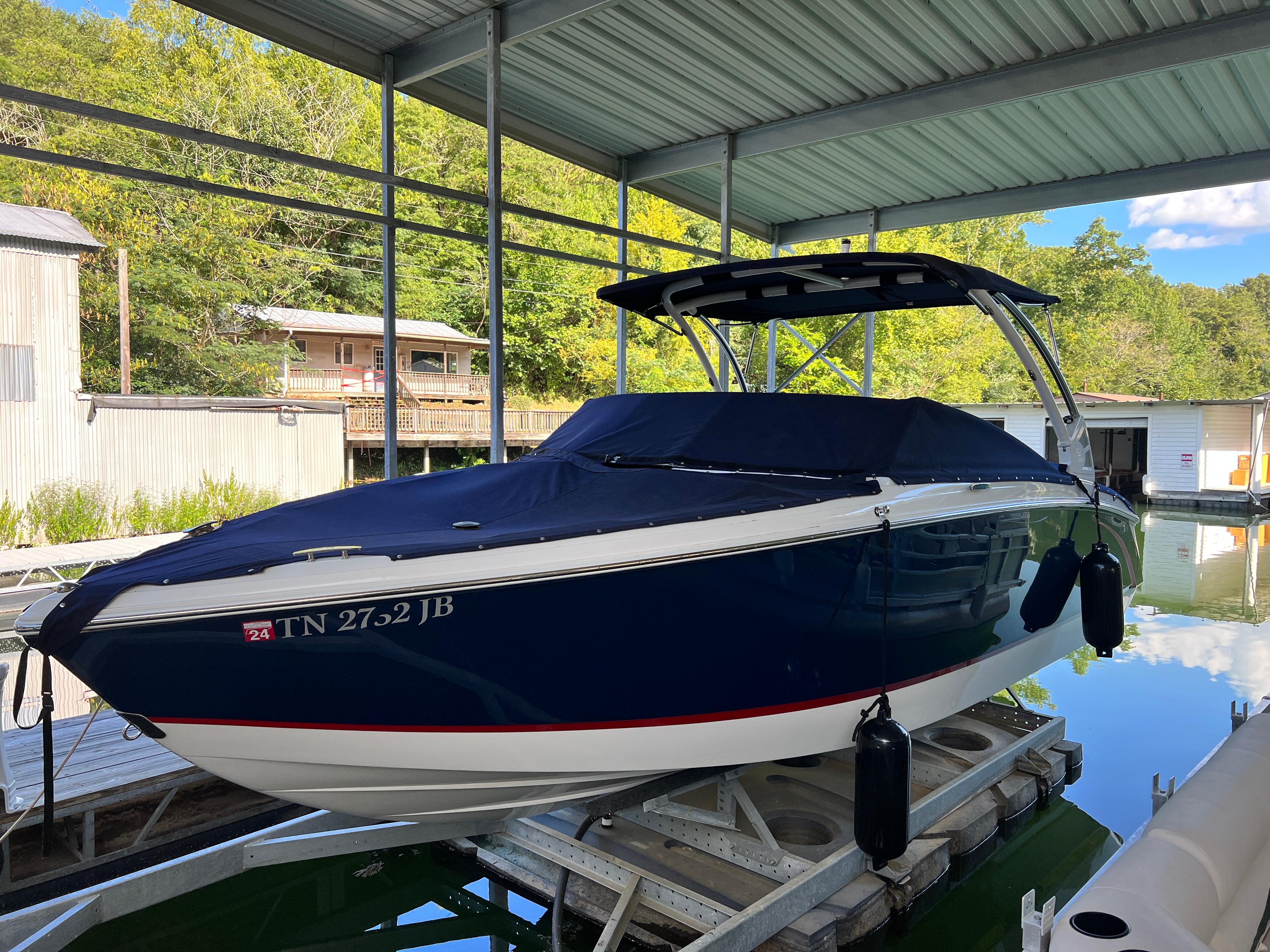 Cobalt R5 2021 Cobalt R5 boat docked under a covered marina.
