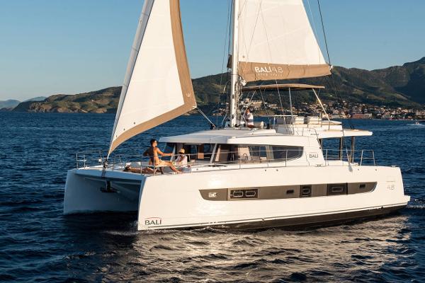 Bali 4.8 2021 Bali 4.8 catamaran sailing on open sea with scenic mountain backdrop.