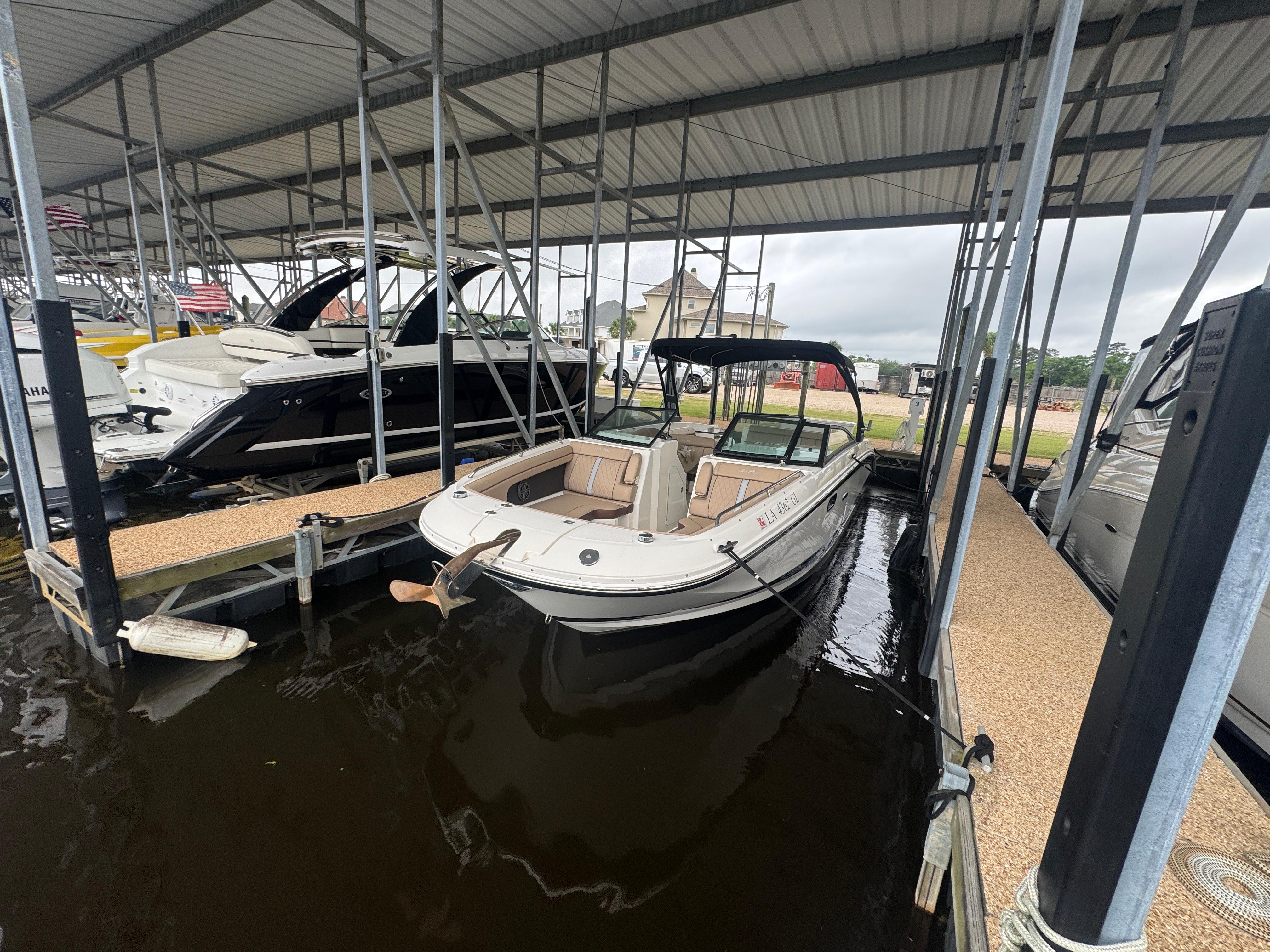 Sea Ray 290 Sundeck 2016 Sea Ray 290 Sundeck boat docked in a covered marina.