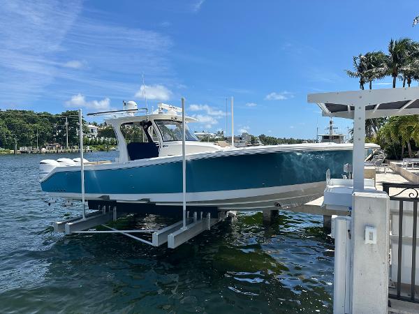 Edgewater 370 CC 2020 Edgewater 370 CC boat docked on a lift by the water.