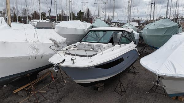 Sea Ray 320 Sundancer 2023 Sea Ray Sundancer 320 boat in storage, surrounded by covered boats.