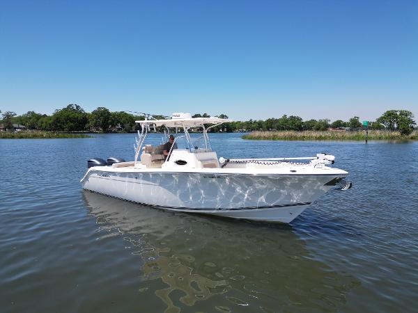 Cobia 296 Center Console 2013 Cobia 296 Center Console boat on calm water under clear blue sky.