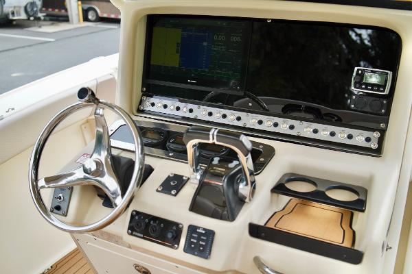 Scout 282 Sportfish 2009 Scout 282 Sportfish boat dashboard with steering wheel and navigation controls.