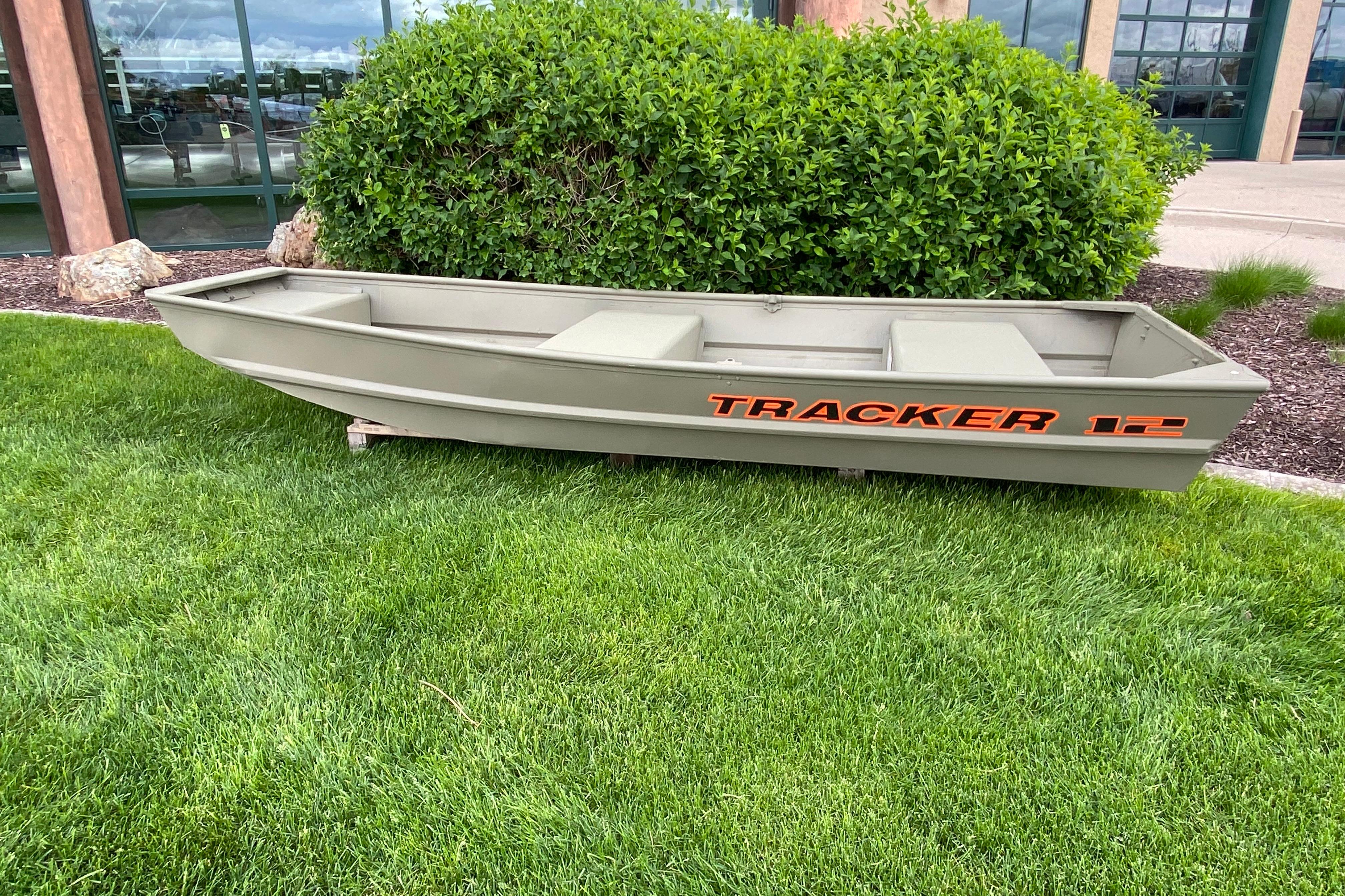 Tracker Grizzly 12 Jon 2026 Tracker Grizzly 12 Jon boat on grass, near bushes and building.
