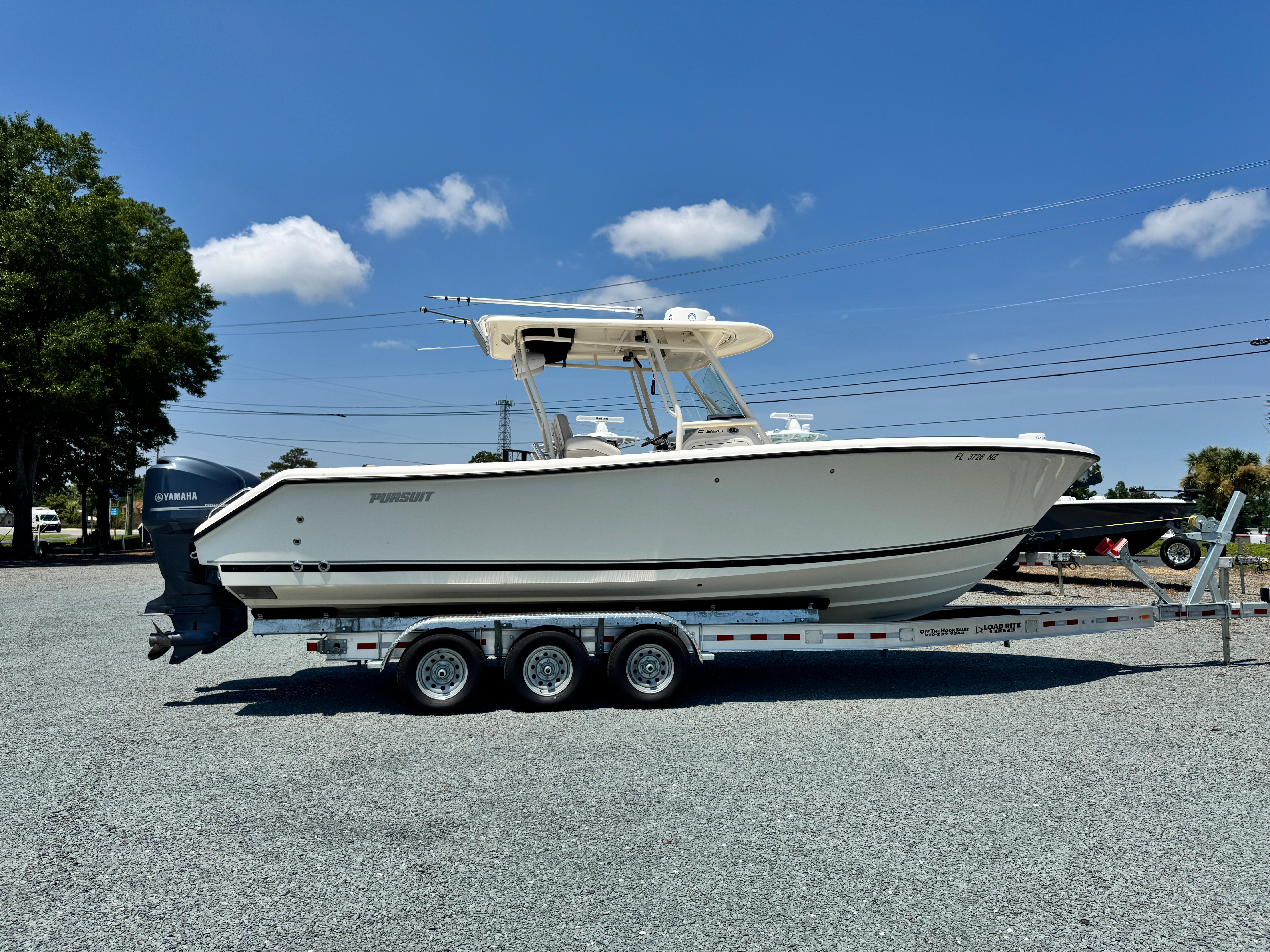 Pursuit C 280 Center Console 2010 Pursuit C 280 Center Console boat on trailer, clear sky background.