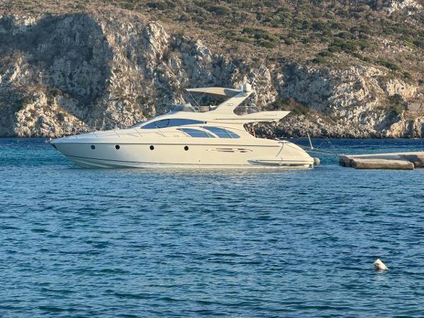 Azimut 50 Luxury 2006 Azimut 50 yacht anchored near rocky coastline.
