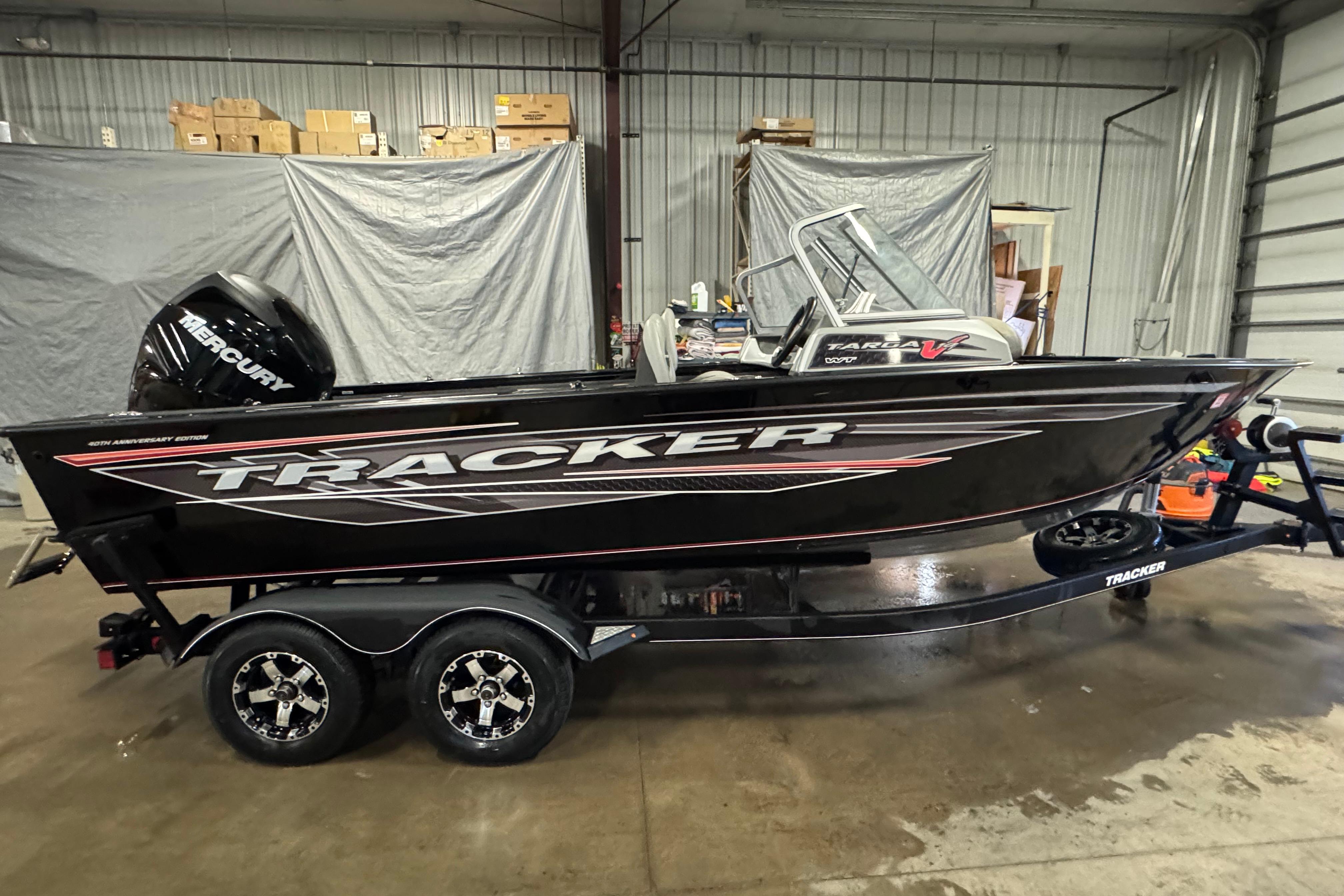 Tracker Targa V-19 Combo 40th Anniversary Edition 2018 Tracker Targa V-19 WT boat in a garage, featuring a Mercury engine.