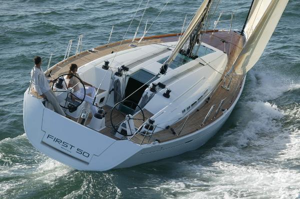 Beneteau First 50 2007 Beneteau First 50 sailboat navigating ocean waters with two people onboard.