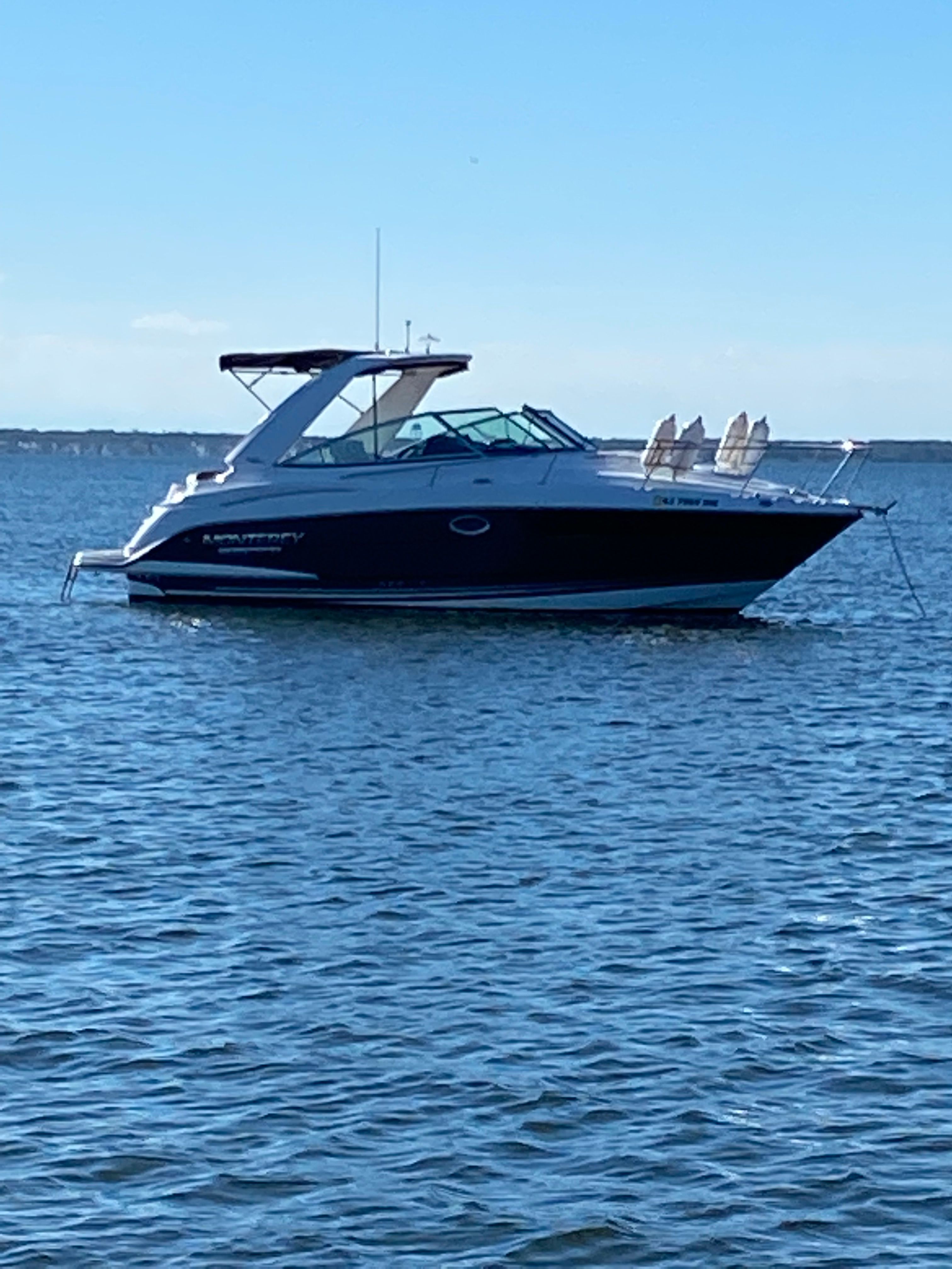 Monterey 295 Sport Yacht 2019 Monterey 295 Sport Yacht on calm water under clear blue sky.