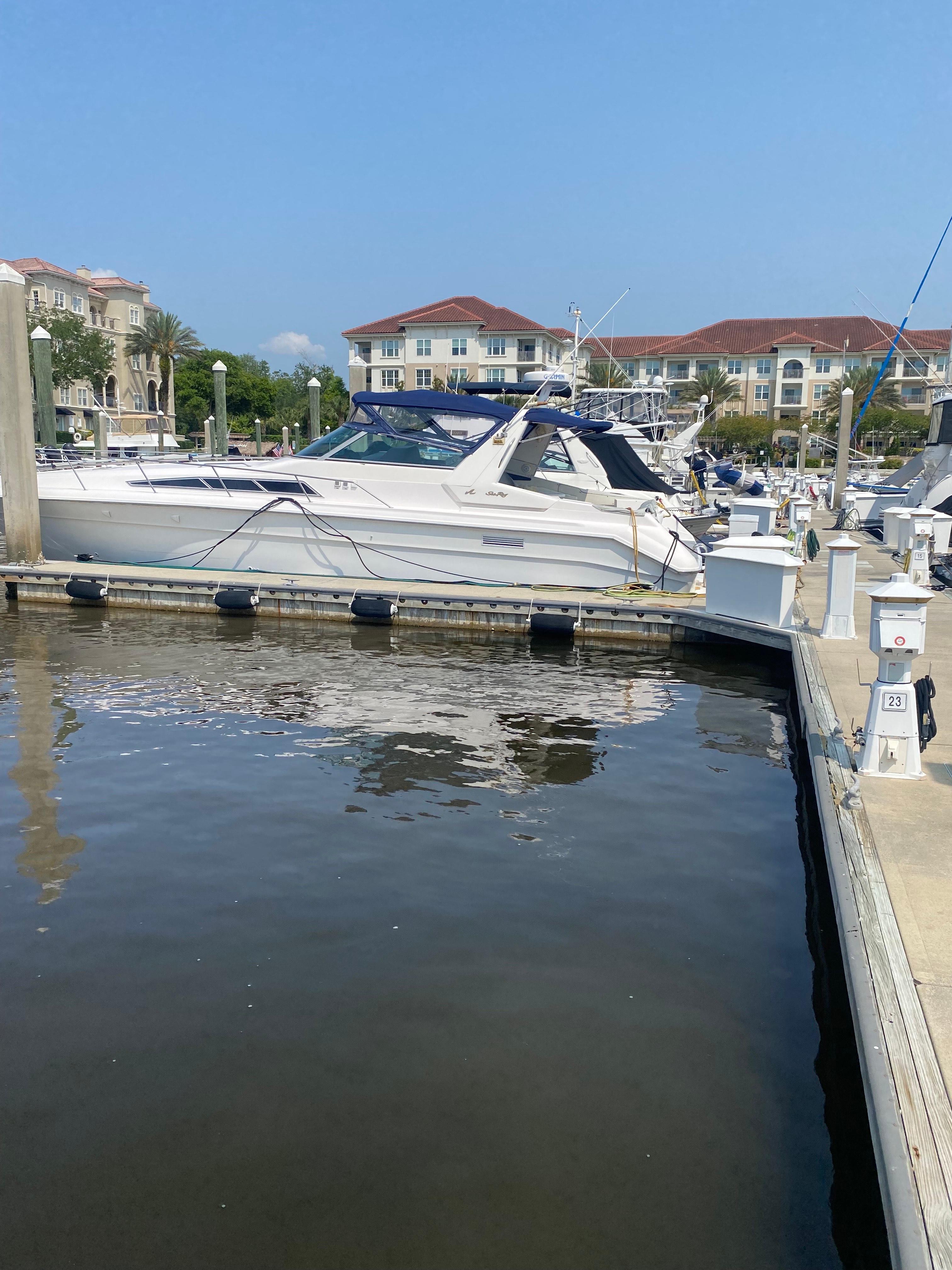 Sea Ray 440 Sundancer 1993 Sea Ray 440 Sundancer docked at a marina with waterfront buildings in the background.