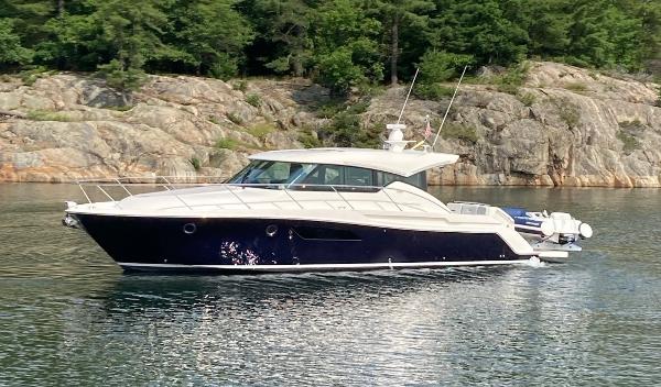 Tiara Yachts C44 Coupe 2018 Tiara Yachts 44 Coupe cruising on a serene lake with rocky shoreline.