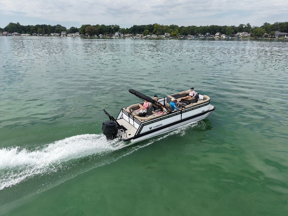 Viaggio V20U 2026 Viaggio V20U pontoon boat cruising on a serene lake with passengers onboard.