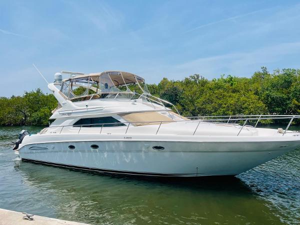 Sea Ray 450 Express Bridge 2000 Sea Ray 450 Express Bridge yacht docked in a serene waterway.