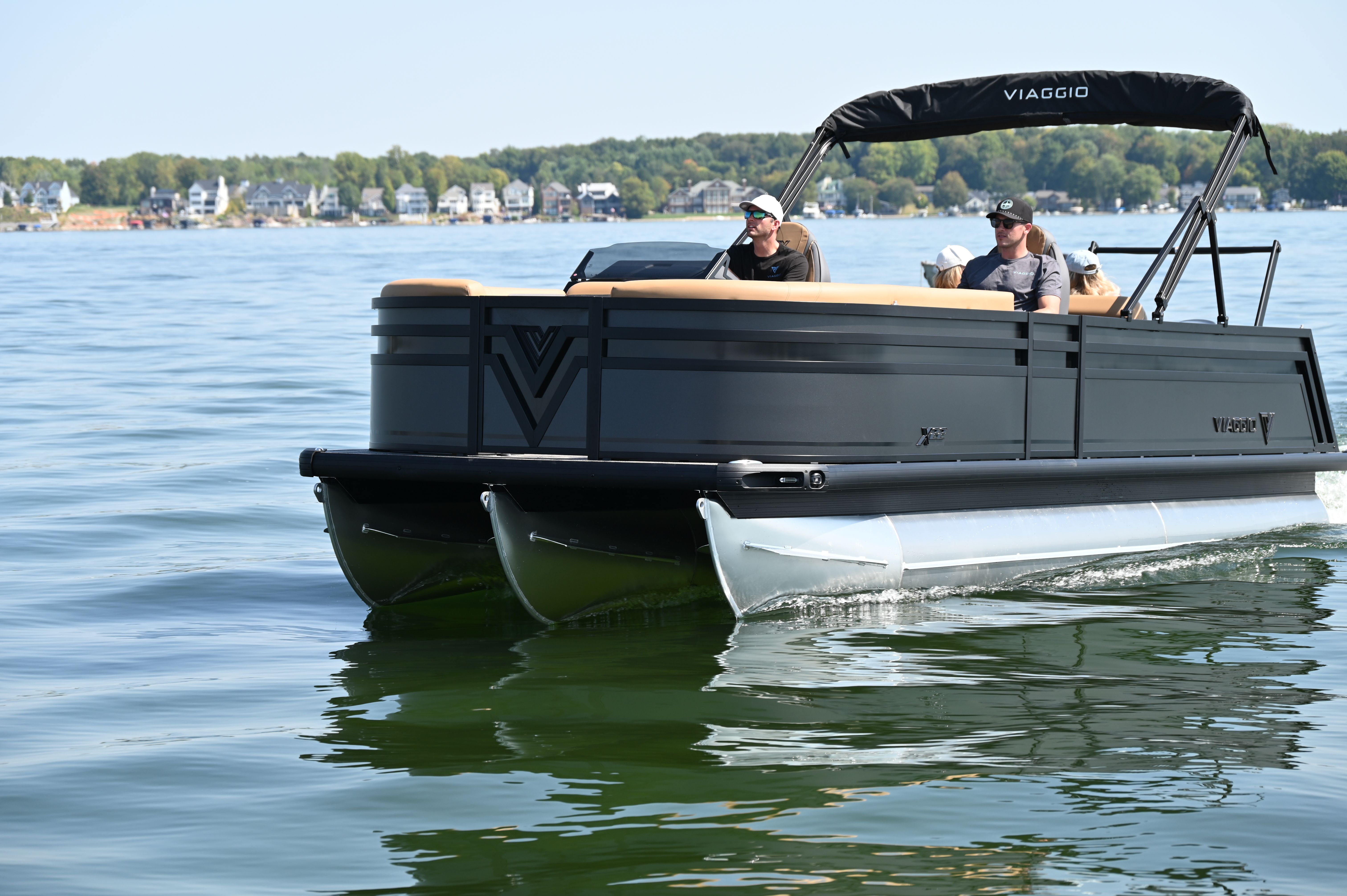 Viaggio x22u 2026 Viaggio x22u pontoon boat cruising on a lake with passengers onboard.