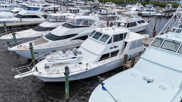 Viking 60 Cockpit Sport Yacht 1996 Viking 60 Cockpit Sport Yacht docked among other luxury boats at a marina.