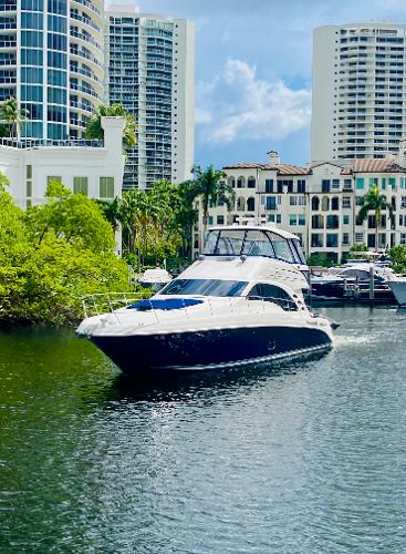 Sea Ray 580 Sedan Bridge 2006 Sea Ray 580 Sedan Bridge yacht cruising near waterfront buildings.
