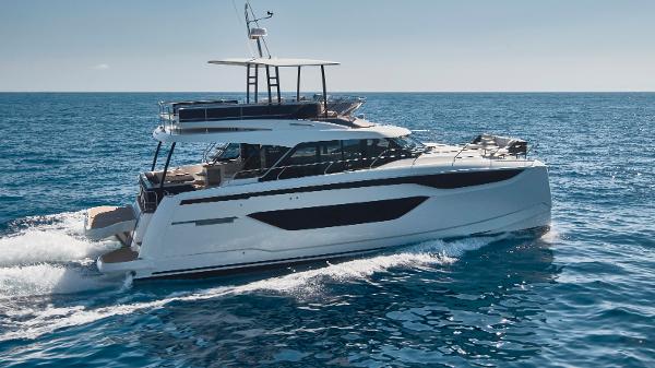 Prestige M48 2025 Prestige M48 yacht cruising on open sea under clear sky.