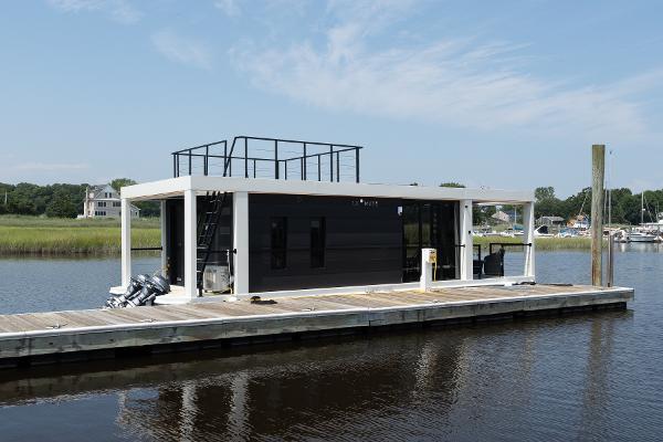Waterlodge Modern 11 Modern Waterlodge 11 houseboat docked on a serene river, 2025 model.