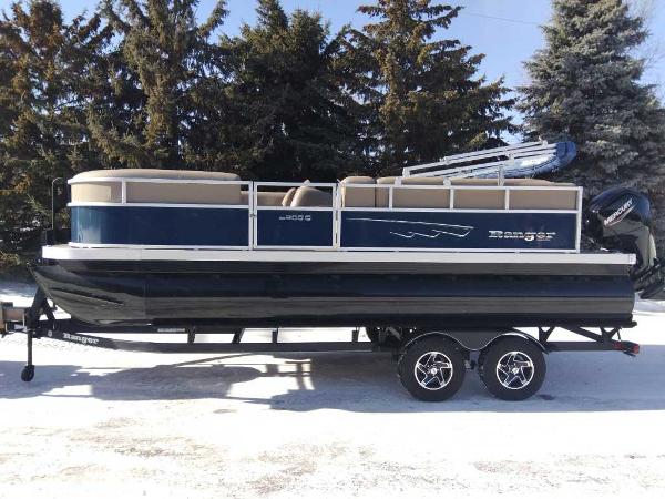Ranger Reata 200C 2024 Ranger Reata 200C pontoon boat on trailer, parked in snowy landscape.