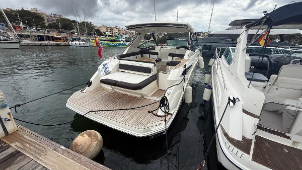 Sea Ray 320 Sundancer 2018 Sea Ray 320 Sundancer docked at marina, overcast sky, adjacent boats visible.