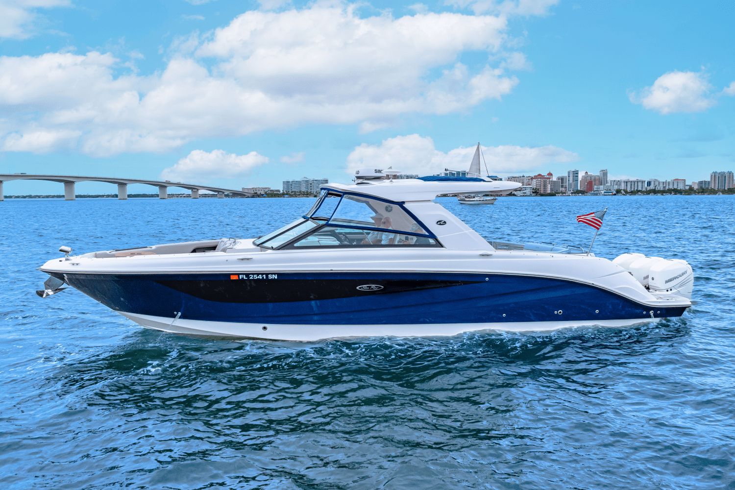 Sea Ray SLX 400 OB 2020 Sea Ray SLX 400 OB boat cruising on blue water with city skyline in background.