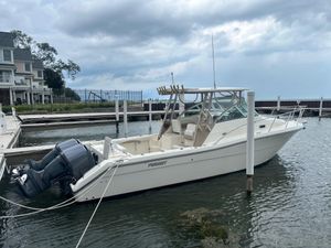 Pursuit 3070 Express 2003 Pursuit 3070 Express boat docked at marina under cloudy sky.