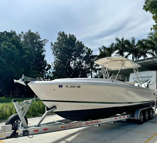Intrepid 327 Center Console 2001 Intrepid 327 Center Console boat on trailer, surrounded by trees.