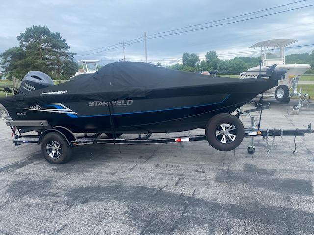 Starweld Fusion Pro 18 DC 2019 Starweld Fusion Pro 18 DC boat on trailer, covered, parked outdoors.
