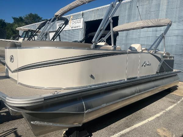 Avalon 2385 LSZ Quad Lounger 2024 Avalon 2385 LSZ Quad Lounger pontoon boat, beige exterior, docked outdoors.