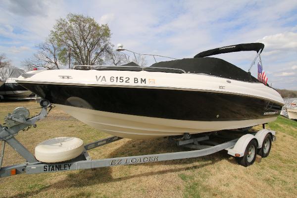 Chaparral 204 SSi 2007 Chaparral 204 SSi boat on trailer, black and white design, parked on grass.